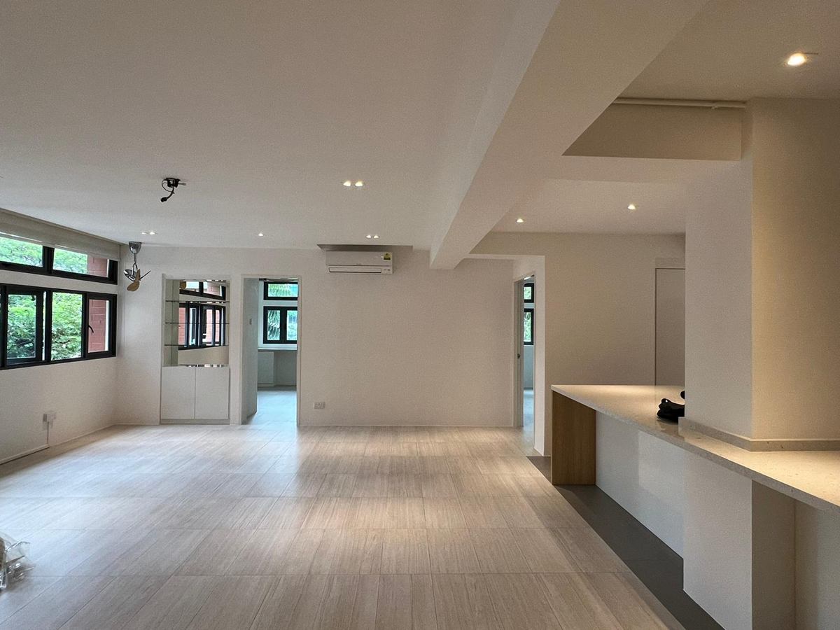 The open living area with pale floors and a long built-in counter.