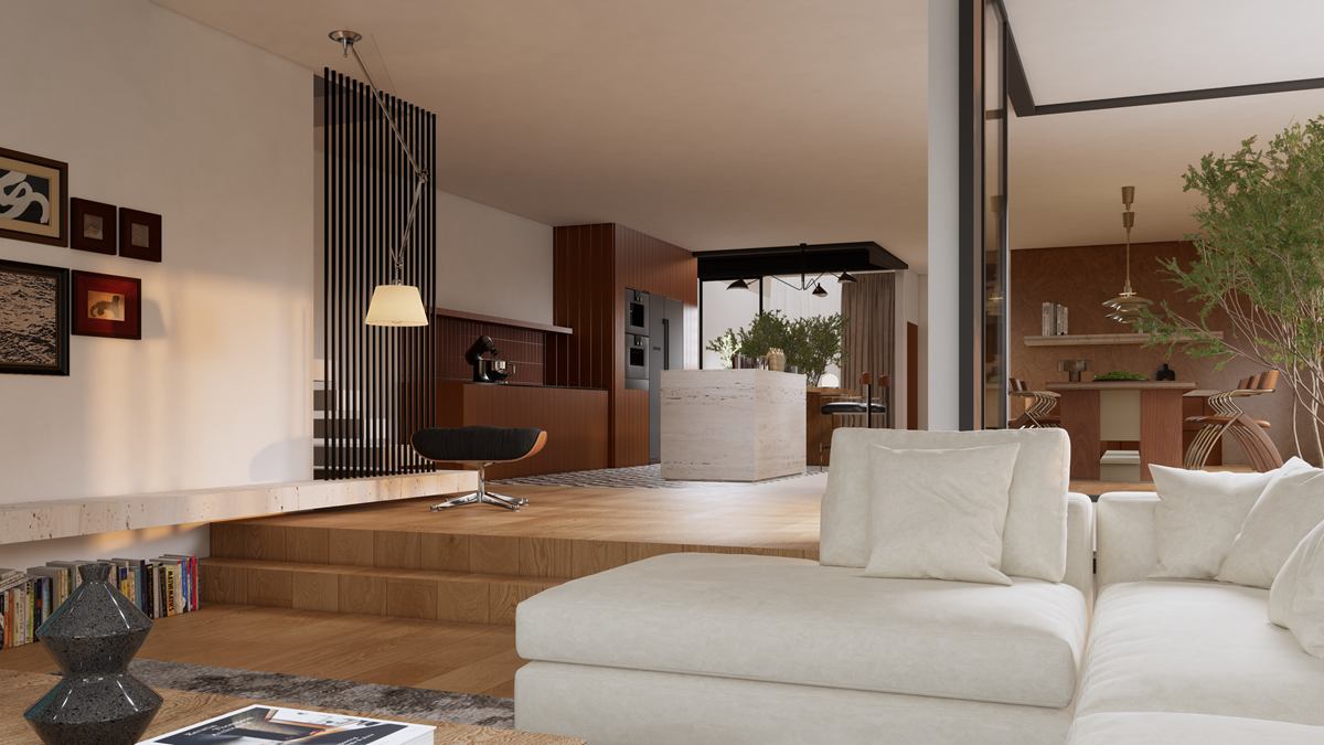The living room with a large white sofa, a raised timber platform and the kitchen beyond.